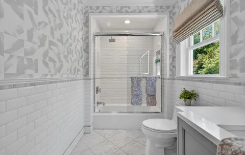 a bathroom with a toilet and a bathtub