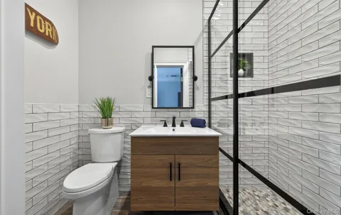 a bathroom with a toilet sink and mirror