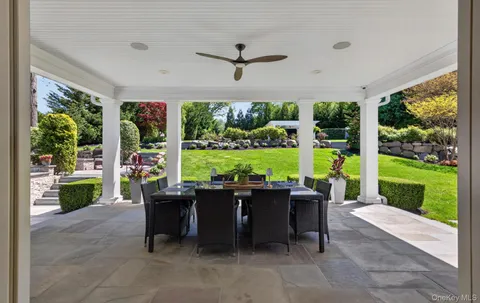 a living room with patio furniture and garden