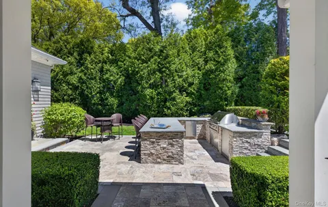 a view of a backyard with sitting area and garden