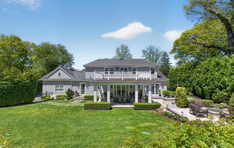 an aerial view of house with yard and outdoor seating