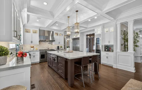 a kitchen with a stove cabinets and wooden floor