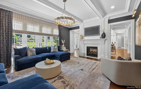 a living room with furniture a fireplace and a large window
