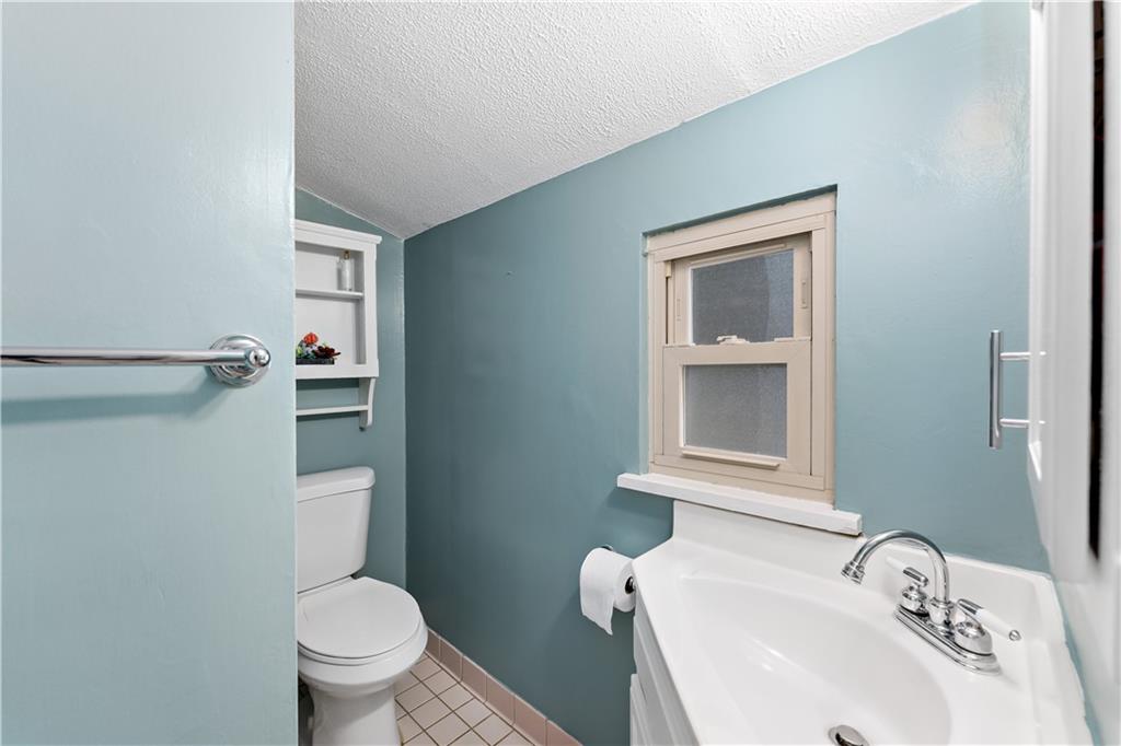 133 Cambridge Road Bethel Park, PA 15102 - Photo 14 of 43 a bathroom with a sink and a toilet