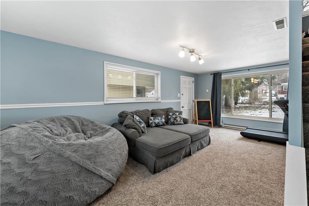 133 Cambridge Road Bethel Park, PA 15102 - Photo 15 of 43 a spacious bedroom with a bed couch and a window