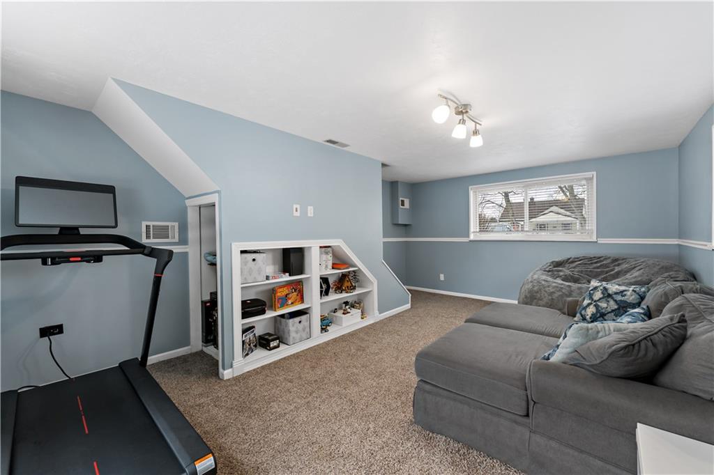 133 Cambridge Road Bethel Park, PA 15102 - Photo 16 of 43 a living room with furniture and a bookshelf