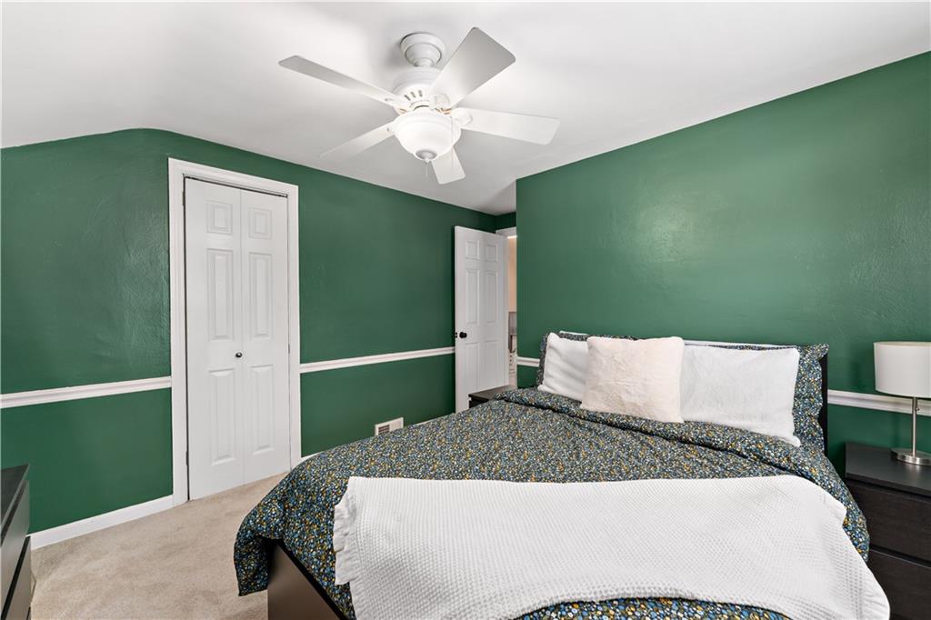 133 Cambridge Road Bethel Park, PA 15102 - Photo 24 of 43 a bedroom with a large bed and a chandelier