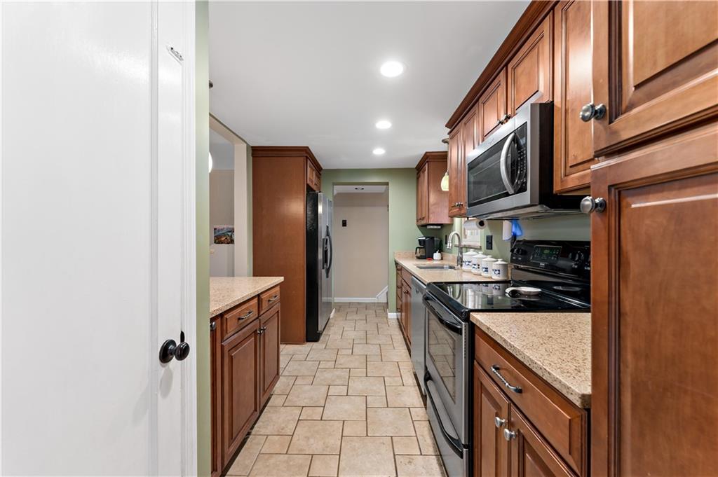 133 Cambridge Road Bethel Park, PA 15102 - Photo 6 of 43 a kitchen with stainless steel appliances granite countertop a stove and a refrigerator