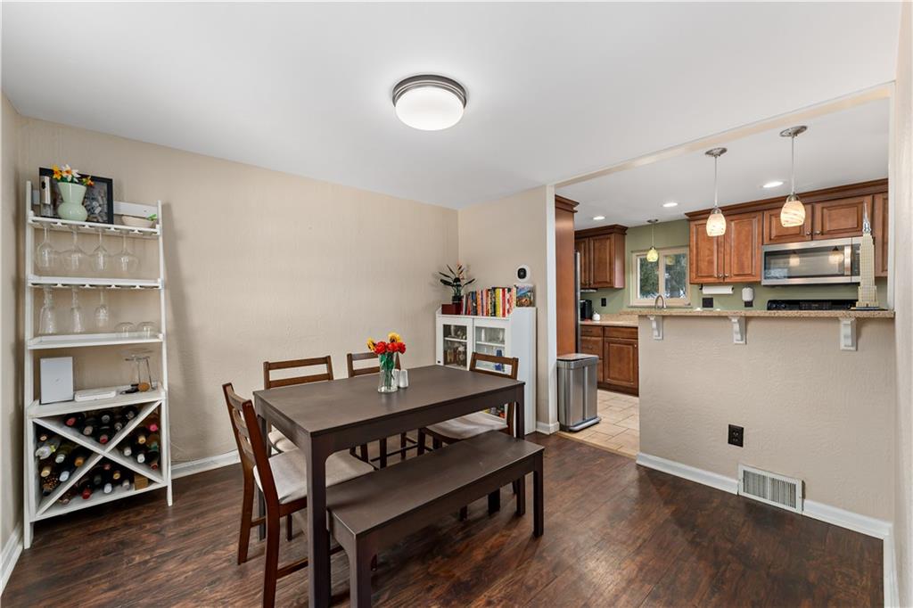 133 Cambridge Road Bethel Park, PA 15102 - Photo 7 of 43 a kitchen with a table chairs refrigerator and microwave