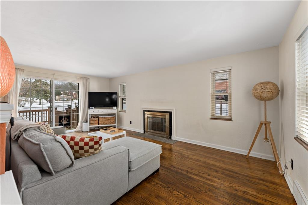 133 Cambridge Road Bethel Park, PA 15102 - Photo 9 of 43 a living room with furniture a flat screen tv and a floor to ceiling window