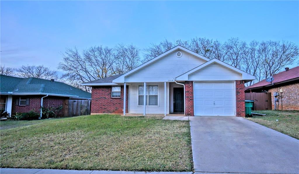 1317 Paco Trail Denton, TX 76209 - Photo 1 of 1 a front view of a house with a yard and garage