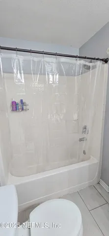 a bathroom with a shower and a bath tub