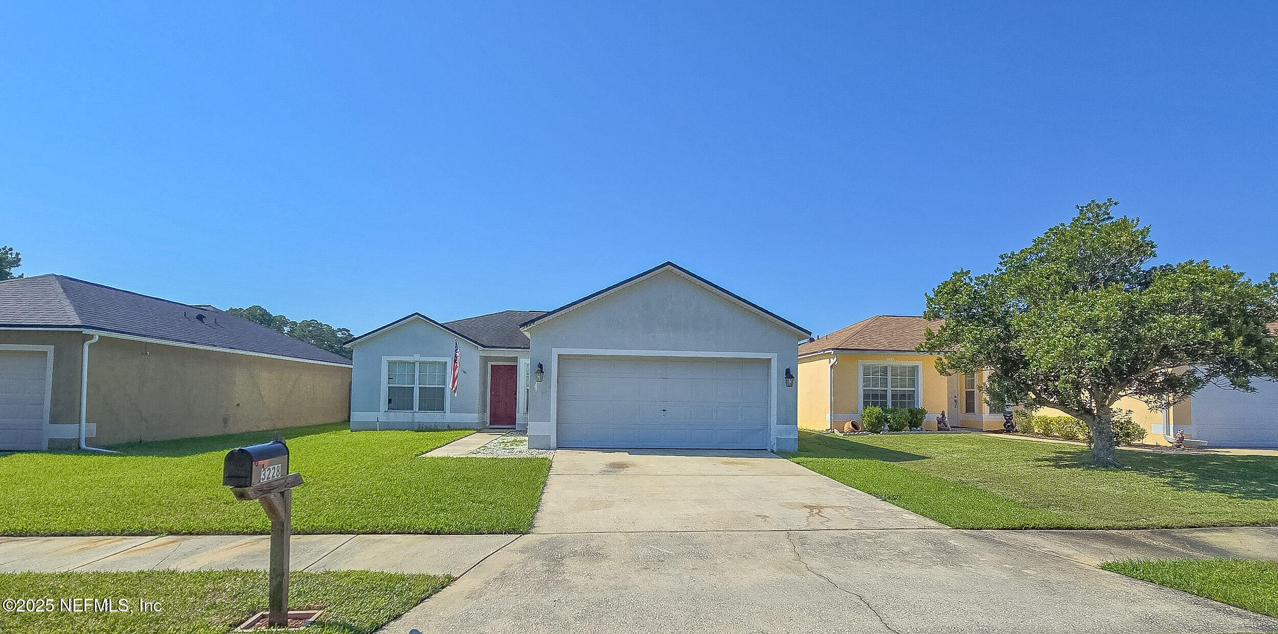 3228 Talisman Drive Middleburg, FL 32068 - Photo 25 of 29 a front view of a house with a garden and yard