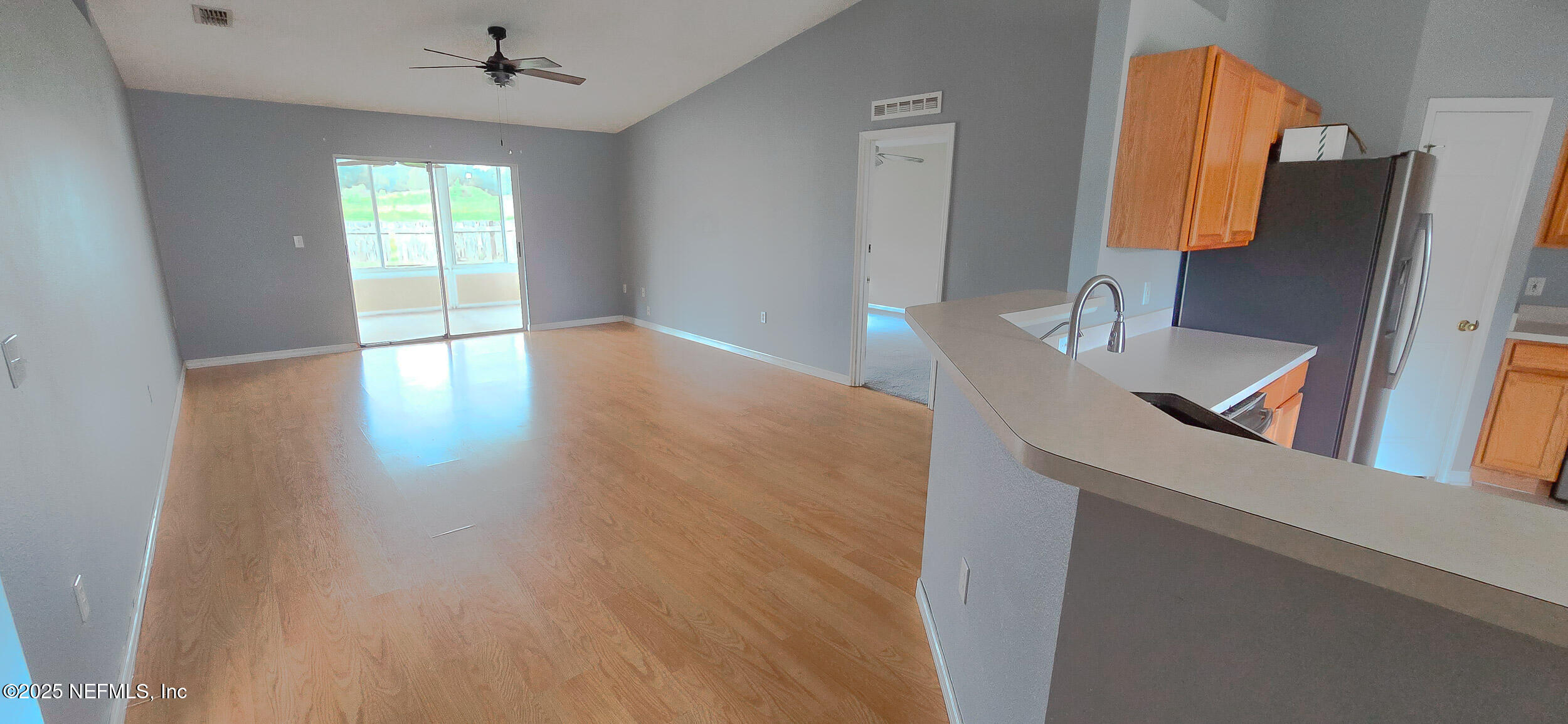 3228 Talisman Drive Middleburg, FL 32068 - Photo 3 of 29 a view of a kitchen with wooden floor and a cabinet