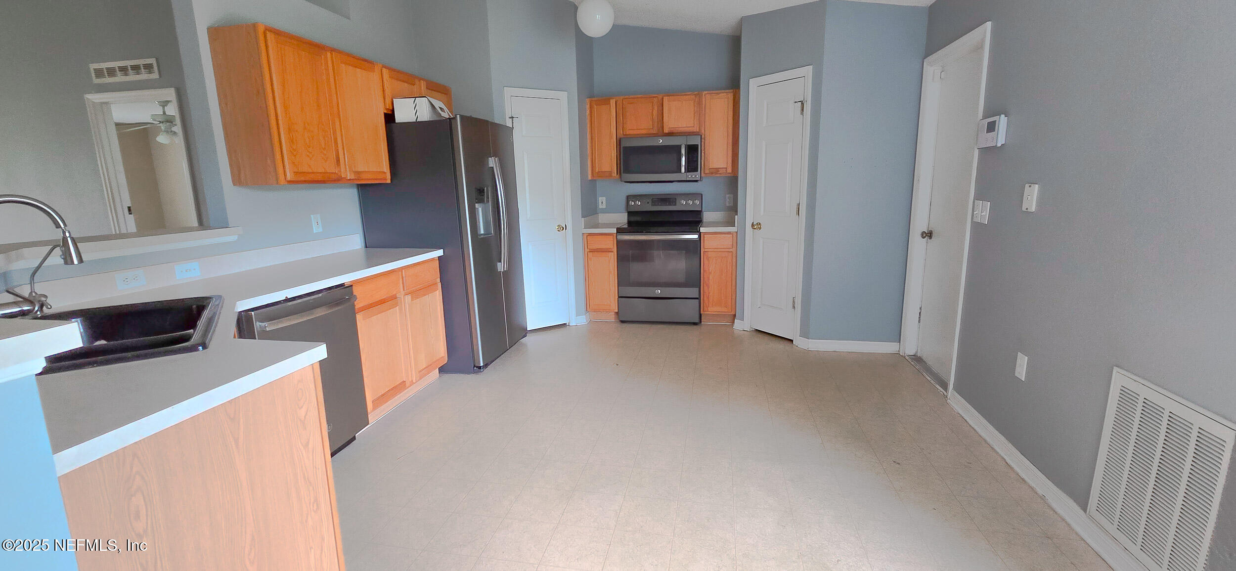 3228 Talisman Drive Middleburg, FL 32068 - Photo 4 of 29 a kitchen with stainless steel appliances granite countertop a refrigerator and a sink