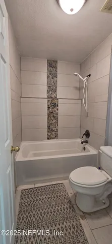a bathroom with a black white checkered floor