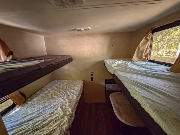 a bed sitting in a bedroom next to a window