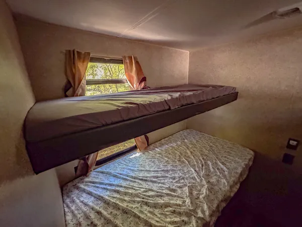 a bedroom with a bed and a mirror