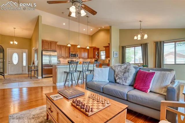 a living room with furniture and a chandelier