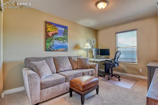 a living room with furniture and a work place