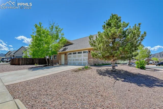 a front view of a house with a yard and a garage