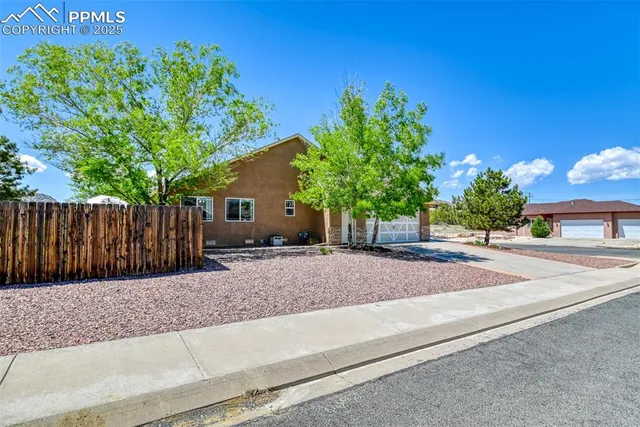 a view of a house with a yard and tree s