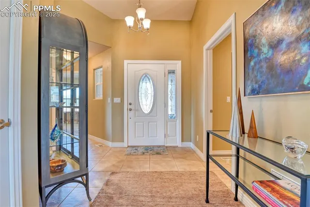 a view of a hallway with windows and chandelier