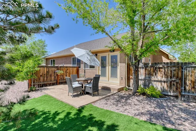 a view of a house with a yard and sitting area