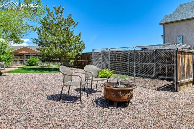 a view of a backyard with furniture and a garden