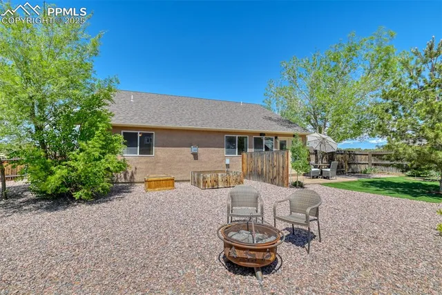 a view of a house with backyard sitting area and swimming pool