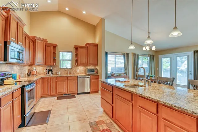 a large kitchen with a large counter top appliances and cabinets