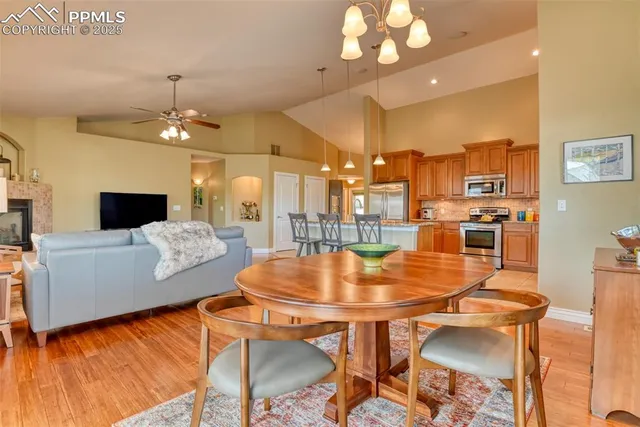 a living room with dining table and a flat screen tv