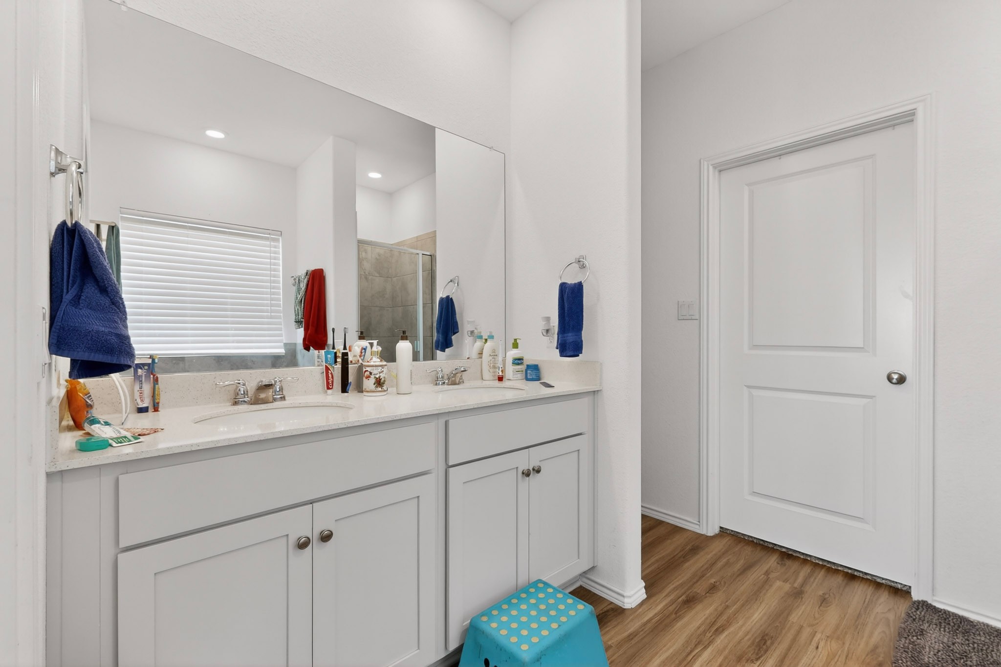 936 Mallow Road Leander, TX 78641 - Photo 10 of 16 Double vanity featuring undermount sinks, stone countertops, and ample storage cabinetry