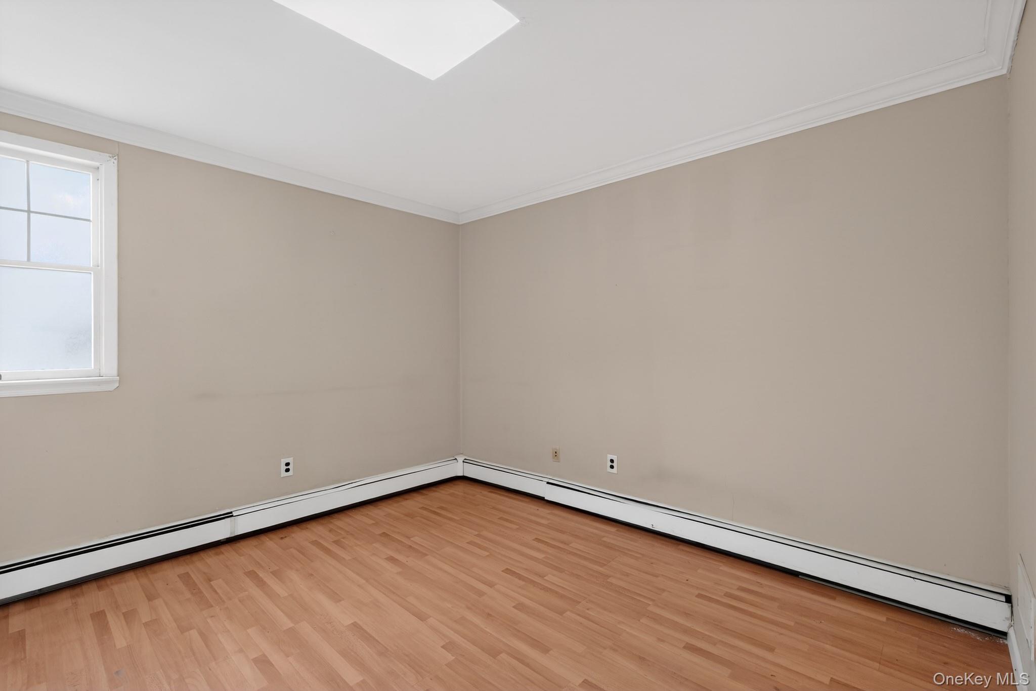 138 Spring Street Massapequa, NY 11758 - Photo 16 of 45 a view of an empty room with wooden floor