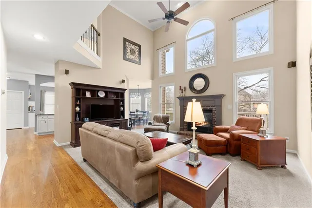 a kitchen with stainless steel appliances granite countertop a table chairs sink and cabinets