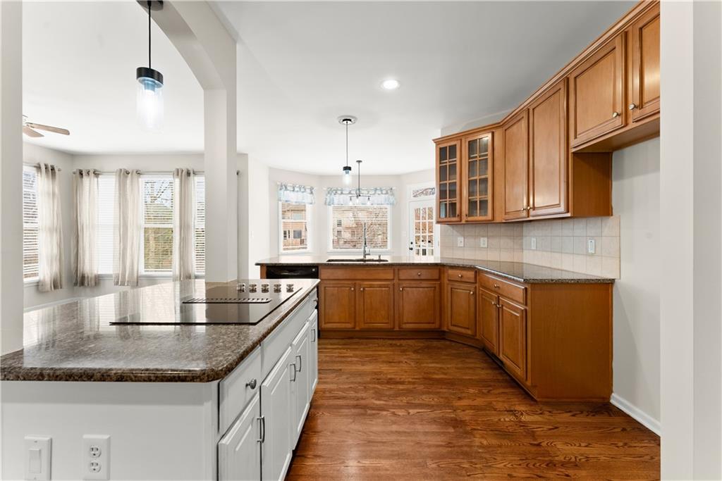 1070 Coleridge Way Suwanee, GA 30024 - Photo 14 of 76 a kitchen with granite countertop a sink stove and cabinets