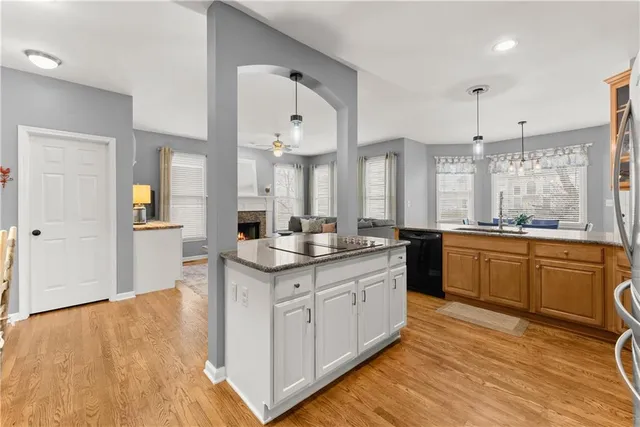 a living room with furniture and a view of kitchen