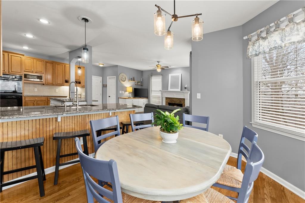 1070 Coleridge Way Suwanee, GA 30024 - Photo 21 of 98 a dining room with stainless steel appliances kitchen island granite countertop a dining table chairs and a refrigerator