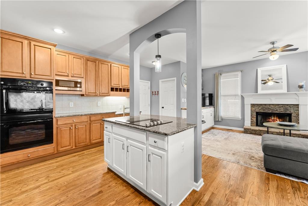 1070 Coleridge Way Suwanee, GA 30024 - Photo 25 of 98 a kitchen with granite countertop a stove top oven sink and cabinets