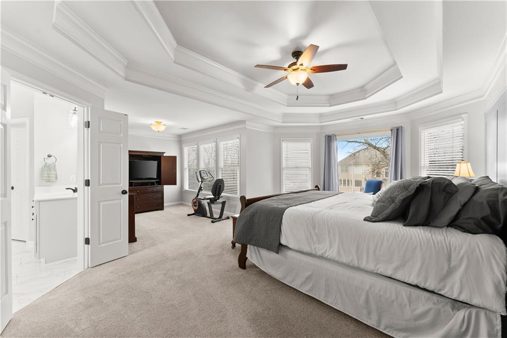 1070 Coleridge Way Suwanee, GA 30024 - Photo 26 of 76 a bedroom with bed and a chandelier