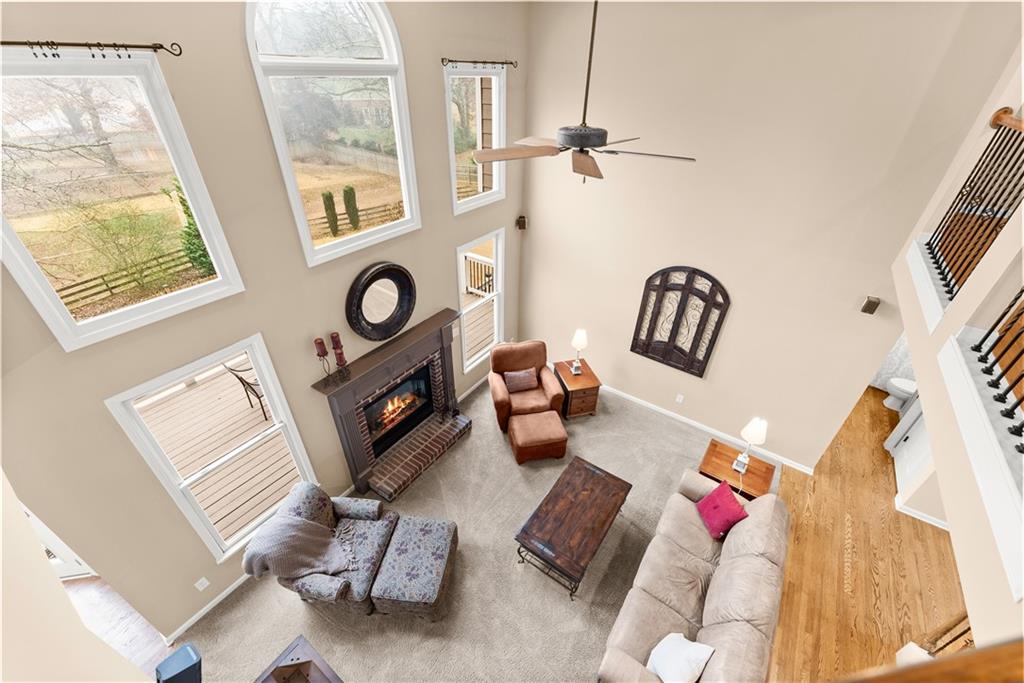 1070 Coleridge Way Suwanee, GA 30024 - Photo 27 of 98 a living room with furniture and a fireplace