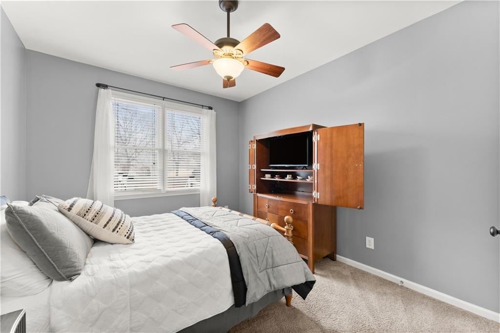 1070 Coleridge Way Suwanee, GA 30024 - Photo 29 of 98 a bedroom with a bed and a flat screen tv