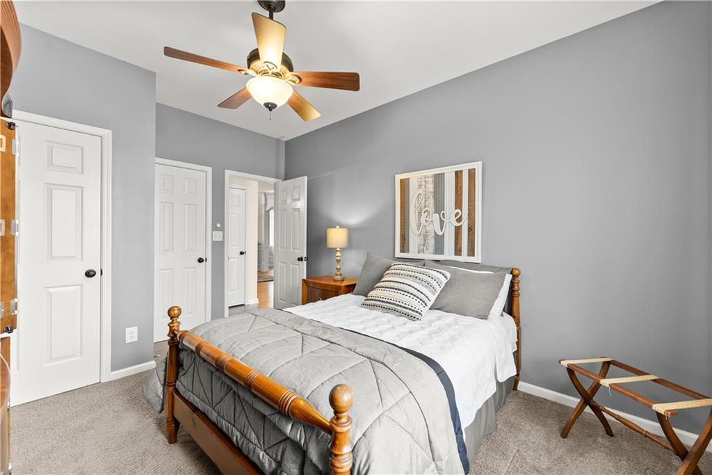 1070 Coleridge Way Suwanee, GA 30024 - Photo 30 of 98 a bedroom with a bed and a chandelier