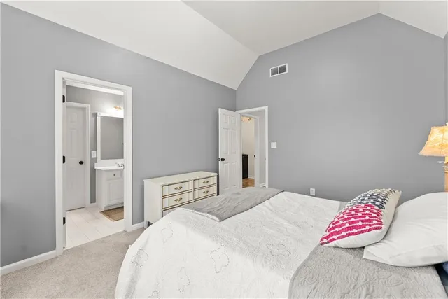 a bedroom with a bed lamp and a window