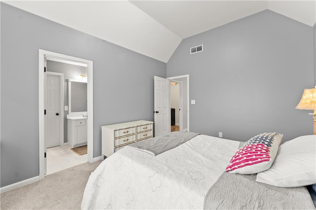 1070 Coleridge Way Suwanee, GA 30024 - Photo 38 of 76 a bedroom with a bed and a cabinets