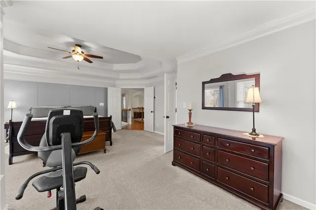 a bedroom with furniture and a chandelier fan