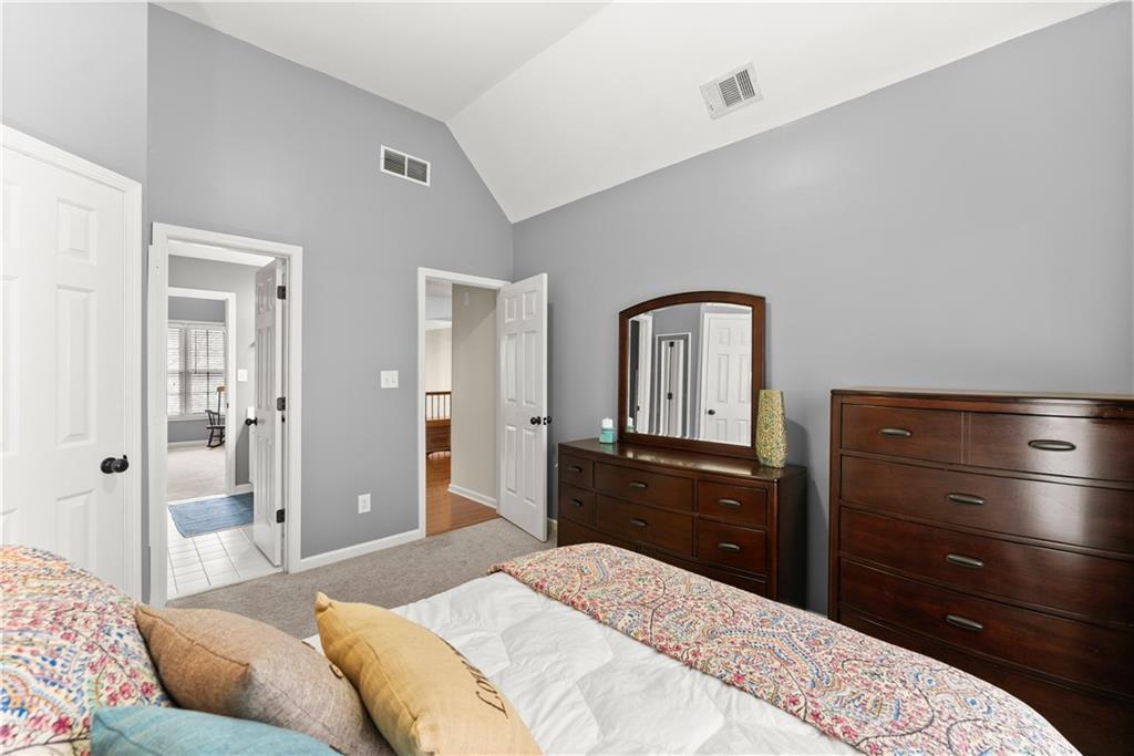 1070 Coleridge Way Suwanee, GA 30024 - Photo 43 of 76 a bedroom with a bed and a dresser