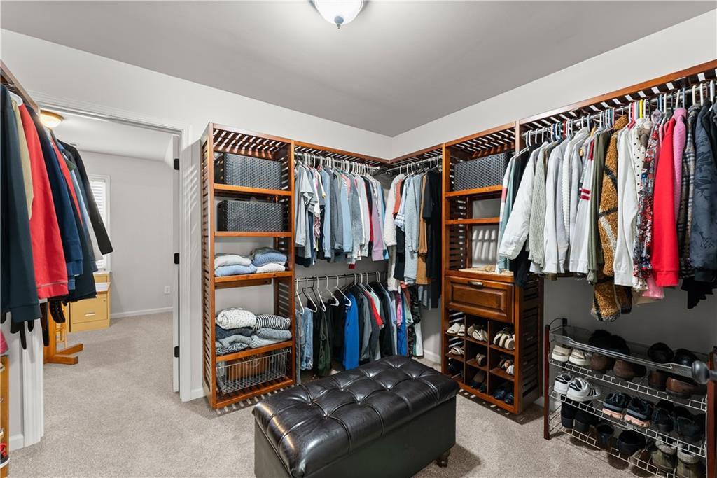 1070 Coleridge Way Suwanee, GA 30024 - Photo 45 of 98 a view of walk in closet with clothes and shoes