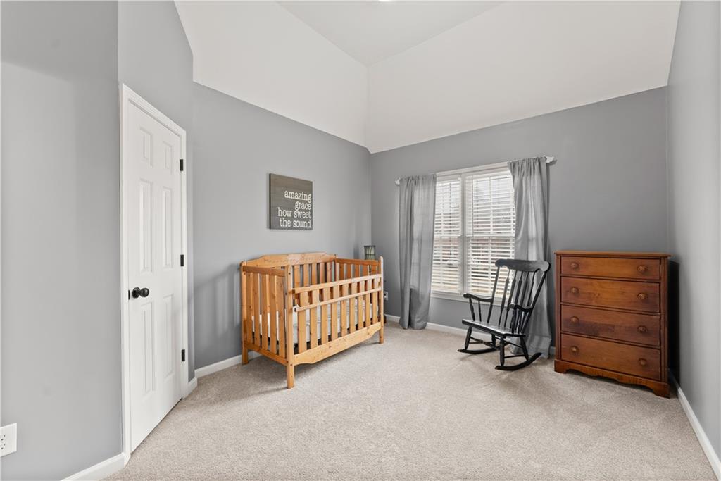 1070 Coleridge Way Suwanee, GA 30024 - Photo 45 of 76 a room with a baby bed and a chair