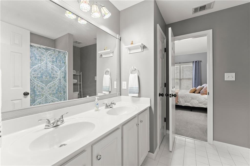 1070 Coleridge Way Suwanee, GA 30024 - Photo 49 of 98 a en suite bathroom with a double vanity sink and mirror